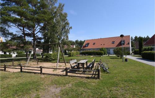 a park with a playground with a wooden swing at Holiday Home Visby 49 in Visby
