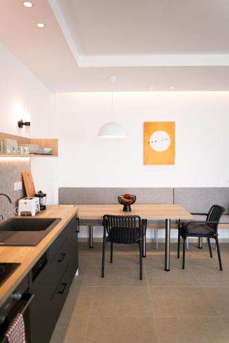 a kitchen with a table and two chairs and a table at Physis Fokida in Eratini