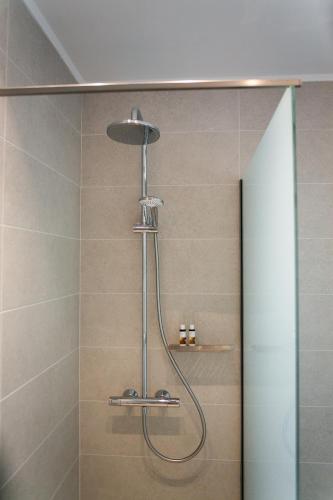 a shower with a shower head in a bathroom at Physis Fokida in Eratini