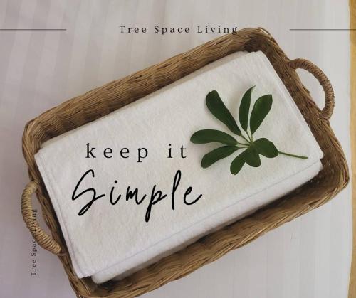 a sign that says keep it simple with a green leaf at Tree Space Living in Ban Don Ta Koet