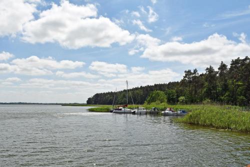 a couple of boats are docked on a lake at Ferienwohnung mit Terrasse in Gustow