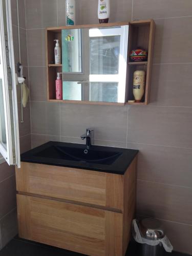 a bathroom with a black sink and a window at Minori in Montpellier