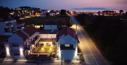 a large white house with a street at night at Mistral Studios in Fanárion