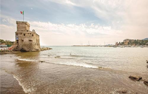 an old castle on the shore of a body of water at Lovely Apartment In Rapallo Ge in Santʼ Anna
