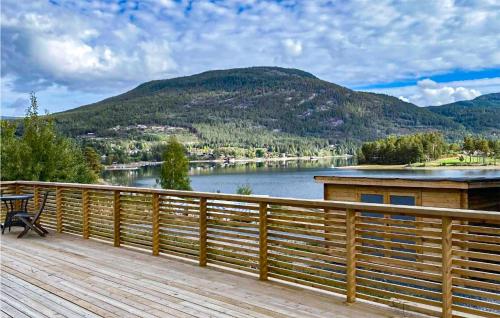 a wooden deck with a view of a lake at Awesome Home In Vrådal With Lake View in Vradal
