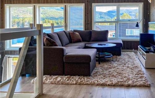 a living room with a couch and a table at Awesome Home In Vrådal With Lake View in Vradal