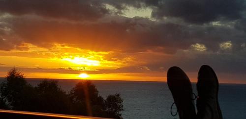 a sunset over the ocean with two surfboards at Hallett Cove Hideaway By Host Solutions in Halletts Cove