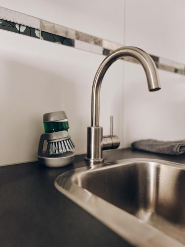 a kitchen counter with a sink and a mixer at Neuwertiges Apartment mit schnellem WLAN, Glasfaser, Kostenlose Privatparkplatz auch für Transporter geeignet R11 in Freiberg am Neckar
