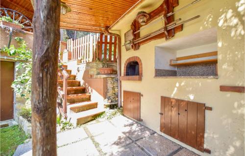 an external view of a house with wooden doors and stairs at Cozy Home In Massarosa With Kitchen in Massarosa