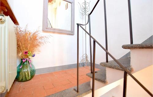 a vase with flowers in it next to a staircase at Cozy Home In Massarosa With Kitchen in Massarosa