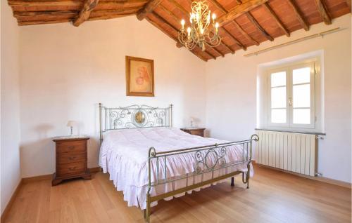 a bedroom with a bed and a chandelier at Cozy Home In Massarosa With Kitchen in Massarosa