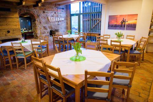 a dining room with tables and chairs in a building at Válaszút Fogadó in Păuleni-Ciuc