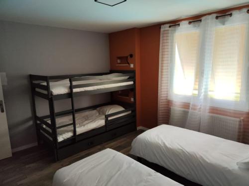 une chambre avec deux lits superposés et une fenêtre dans l'établissement Gite Saint Barthelemy le Plain - Village, à Saint-Barthélemy-le-Plain
