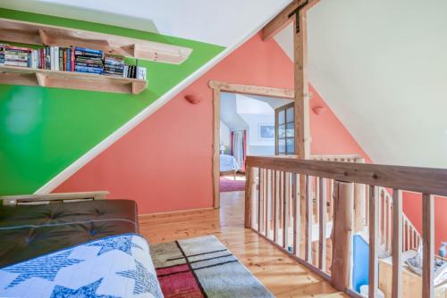 a room with a staircase with green and orange walls at Dream Sea Chalet in Yachats