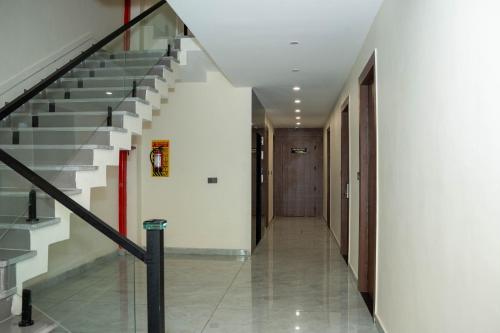 a hallway of a building with stairs and a door at Hotel W Grand - A Boutique Hotel in Haridwār