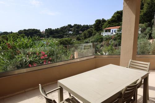 a white table and chairs on a balcony at Cape Kanapitsa Hotel & Suites in Kanapitsa