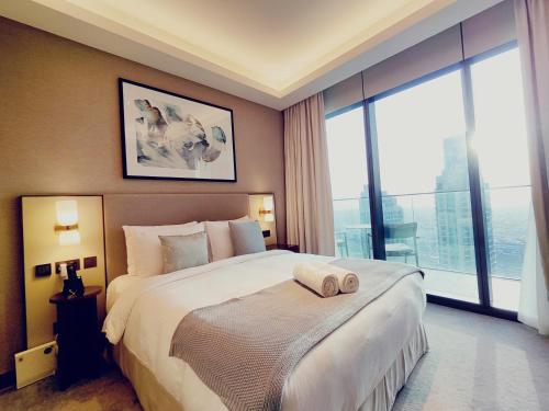 a bedroom with a large bed and a large window at 2BD Luxury Opera District Apt Downtown in Dubai