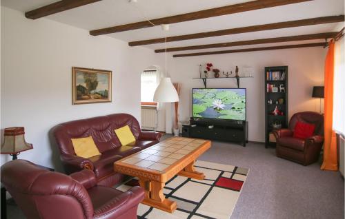 a living room with leather furniture and a flat screen tv at Two-Bedroom Apartment In Arrach in Arrach