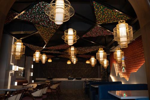 a restaurant with chandeliers hanging from the ceiling at Hotel W Grand - A Boutique Hotel in Haridwār