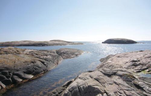 a body of water with rocks in the water at Stunning Apartment In Kungshamn in Kungshamn