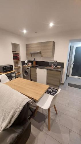 - une cuisine avec une table et des chaises en bois dans la chambre dans l'établissement Maison appartement, à Fénay