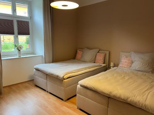 a bedroom with two beds and a window at Charmante Ferienwohnung in Vordernberg - Alpenidylle pur in Vordernberg