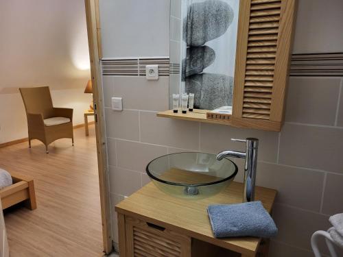 a bathroom with a glass bowl sink on a counter at La marine D'opale in Ambleteuse