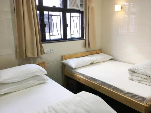 Postel nebo postele na pokoji v ubytování 旅客棧 Time Hostel