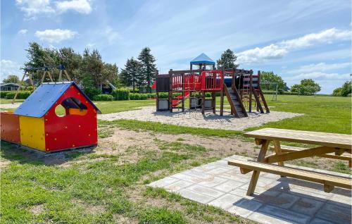 a park with a playground with a wooden bench at Holiday Home Vesterbakken Assens Ii in Assens