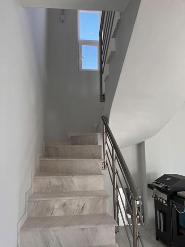 a staircase in a house with a window at Вила in Asprovalta