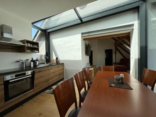 a kitchen and dining room with a long wooden table at Paradies in Bad Radkersburg