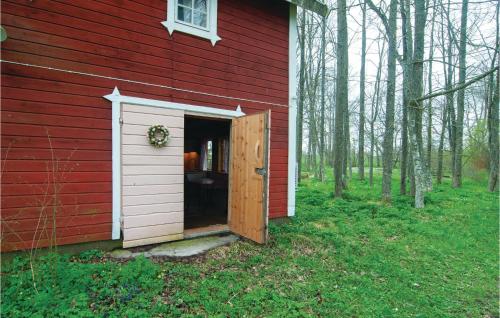 a red house with a door in the side of it at Three-Bedroom Holiday Home In Romakloster in Romakloster