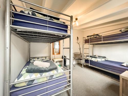 a room with two bunk beds and a desk at Kinloch Wilderness Retreat in Glenorchy
