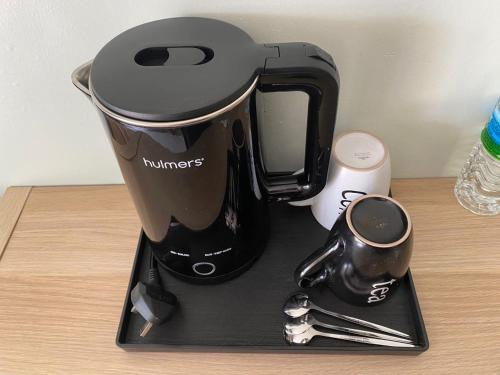 a black coffee maker sitting on a table at Rajawali Riverside Retreat in Dungun