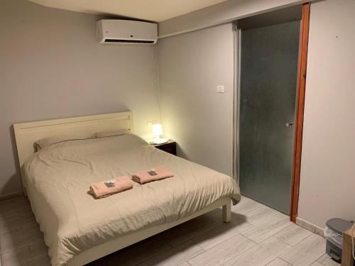 a bedroom with a bed with two towels on it at avraham B''H in Nevatim