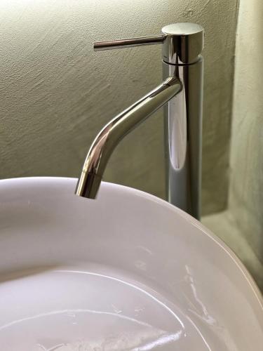 a sink with a faucet in a bathroom at Bruni 18 in Fasano