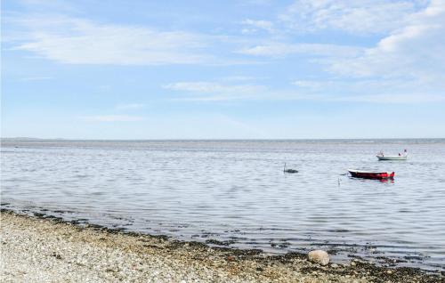 two boats in the water near a beach at Stunning Home In Allingåbro With Wifi in Allingåbro