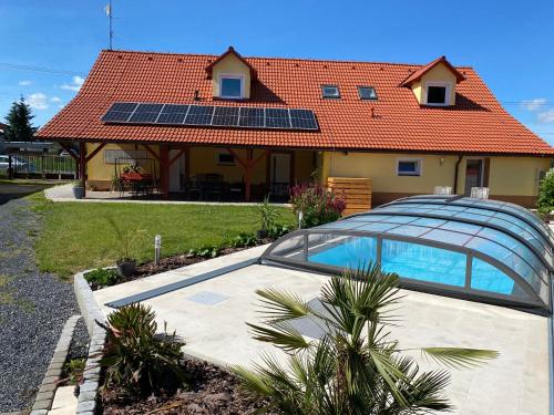 a house with solar panels on the roof at Ubytování ve Starém Dvoře in Třemošnice