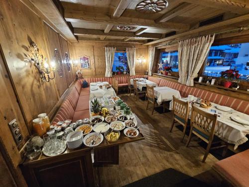 an overhead view of a dining room with plates of food at Hotel Olympia in Lech am Arlberg