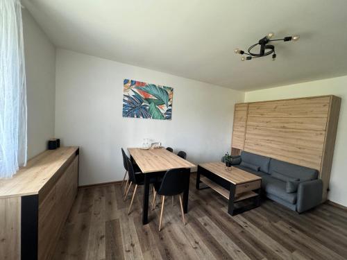 a living room with a table and a couch at ApartmanyVrbno Aktiv in Bruntál
