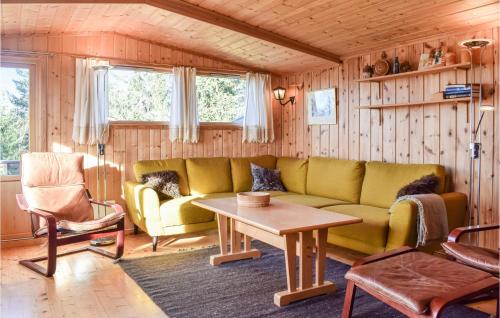 a living room with a couch and a table at Gorgeous Home In Sjusjøen With Sauna in Sjusjøen
