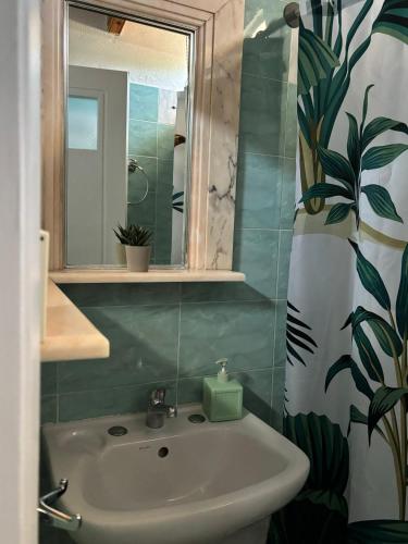 a bathroom with a sink and a mirror at Demis Apartments in Sidari