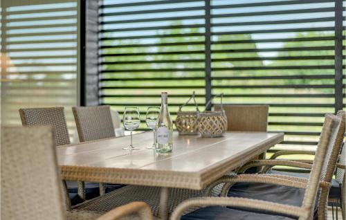 a wooden table with two glasses of wine on it at Lovely Home In Haderslev With Wifi in Haderslev
