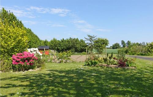 a garden with flowers on the side of a road at Amazing Home In Klemensker With Wifi in Klemensker