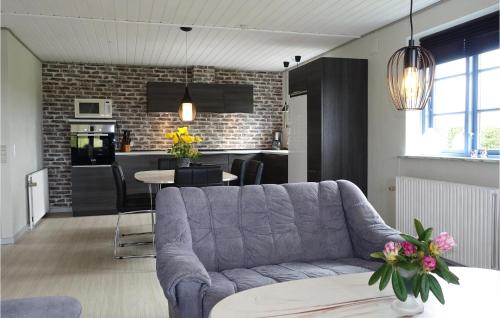 a living room with a couch and a kitchen at Amazing Home In Klemensker With Wifi in Klemensker