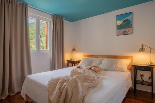 a person laying on a bed in a bedroom at Villas Sole in Bol