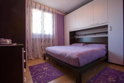 a bedroom with a large bed and a window at Ariete Apartments in Livigno