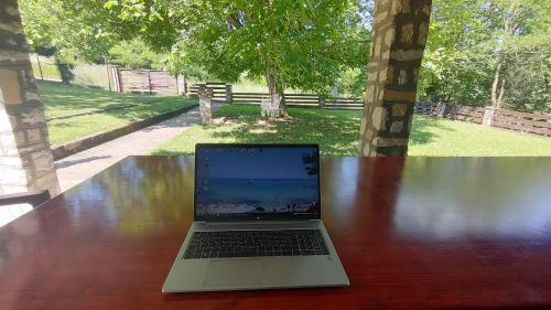 a laptop computer sitting on top of a wooden table at Gorska Vila Sisevac in Sisevac
