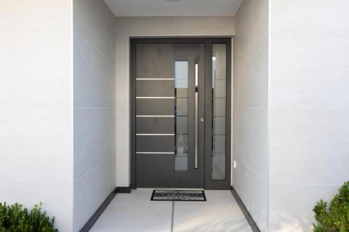 a front door of a white building at Luxury White Sails Villas with a Multi Sport Court #2026# and Sea View in Pinezici