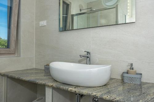 a white sink on a counter in a bathroom at Luxury White Sails Villas with a Multi Sport Court #2026# and Sea View in Pinezici
